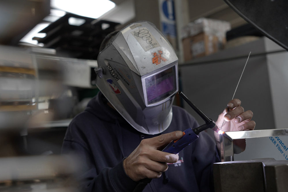 Hand crafting espresso machine body and frame, parts for professional coffee machine for cafes in Italy